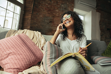 Image showing African-american woman, freelancer during the work in home office while quarantine