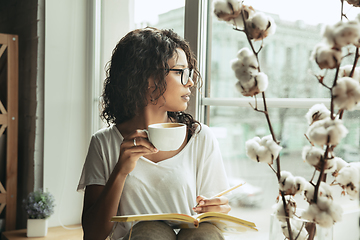 Image showing African-american woman, freelancer during the work in home office while quarantine