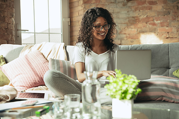 Image showing African-american woman, freelancer during the work in home office while quarantine