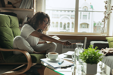 Image showing African-american woman, freelancer during the work in home office while quarantine