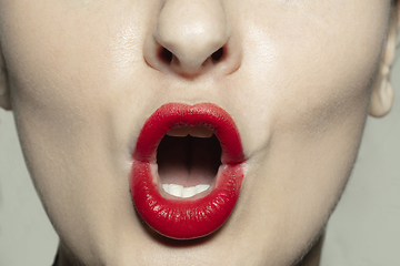 Image showing Close-up female mouth with bright red gloss lips make-up. Cosmetology, dentistry and beauty care, emotions