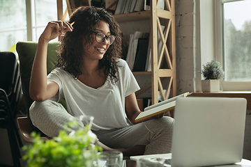 Image showing African-american woman, freelancer during the work in home office while quarantine