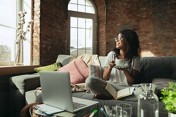 Image showing African-american woman, freelancer during the work in home office while quarantine