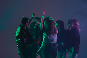 Image showing Cheering dance party, performance concept. Crowd shadow of people dancing with neon lights raised hands up