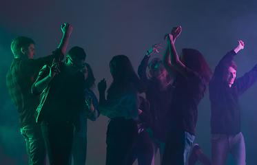 Image showing Cheering dance party, performance concept. Crowd shadow of people dancing with neon lights raised hands up