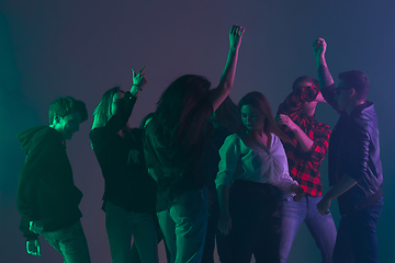 Image showing Cheering dance party, performance concept. Crowd shadow of people dancing with neon lights raised hands up