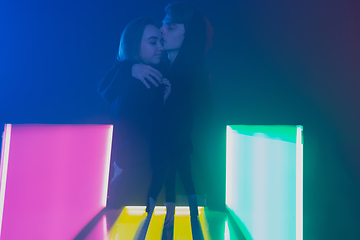 Image showing Cheering dance party, performance concept. Couple hugging in neon lights, romantic and lovely