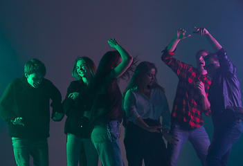 Image showing Cheering dance party, performance concept. Crowd shadow of people dancing with neon lights raised hands up