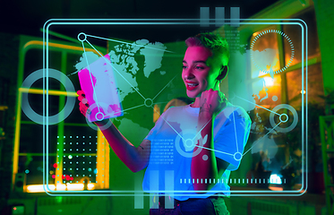 Image showing Woman using interface modern technology and digital layer effect as business, finance, economics strategy concept