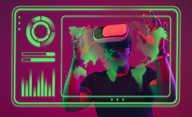 Image showing Woman using interface modern technology and digital layer effect, VR-headset as business, finance, economics strategy concept