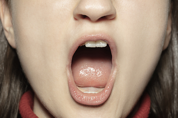 Image showing Close-up female mouth with natural nude gloss lips make-up. Cosmetology, dentistry and beauty care, emotions