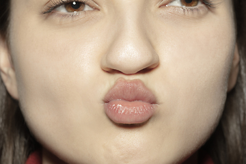 Image showing Close-up female mouth with natural nude gloss lips make-up. Cosmetology, dentistry and beauty care, emotions