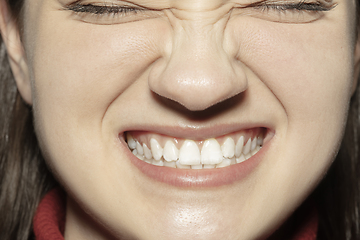 Image showing Close-up female mouth with natural nude gloss lips make-up. Cosmetology, dentistry and beauty care, emotions