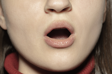 Image showing Close-up female mouth with natural nude gloss lips make-up. Cosmetology, dentistry and beauty care, emotions