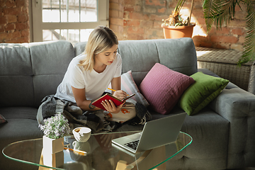 Image showing Caucasian woman, freelancer during the work in home office while quarantine