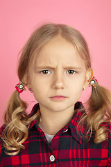 Image showing Caucasian little girl\'s close up portrait on pink studio background