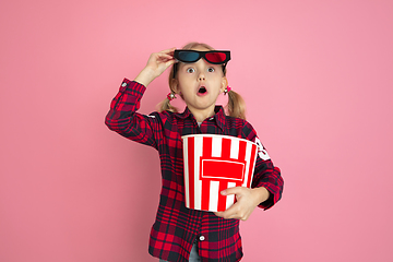 Image showing Caucasian little girl\'s portrait on pink studio background, cinema concept