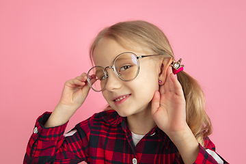 Image showing Caucasian little girl\'s portrait on pink studio background