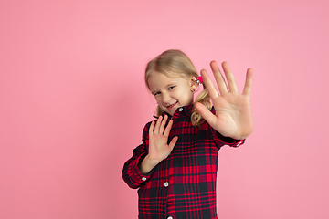 Image showing Caucasian little girl\'s portrait on pink studio background