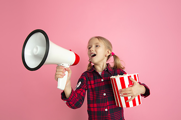 Image showing Caucasian little girl\'s portrait on pink studio background, cinema concept