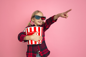 Image showing Caucasian little girl\'s portrait on pink studio background, cinema concept