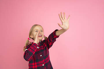 Image showing Caucasian little girl\'s portrait on pink studio background