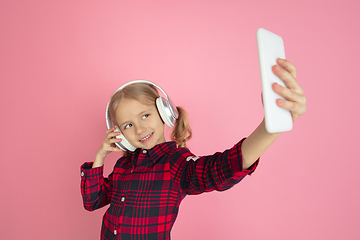 Image showing Caucasian little girl\'s portrait on pink studio background