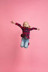 Image showing Caucasian little girl\'s portrait on pink studio background