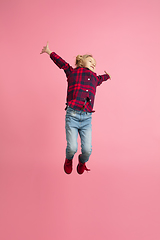 Image showing Caucasian little girl\'s portrait on pink studio background