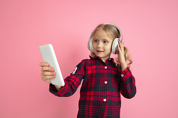 Image showing Caucasian little girl\'s portrait on pink studio background