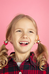 Image showing Caucasian little girl\'s close up portrait on pink studio background