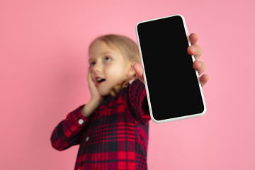 Image showing Caucasian little girl\'s portrait on pink studio background