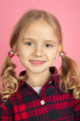 Image showing Caucasian little girl\'s close up portrait on pink studio background