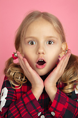 Image showing Caucasian little girl\'s close up portrait on pink studio background