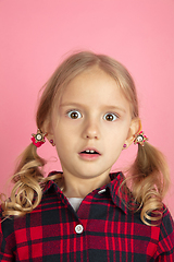 Image showing Caucasian little girl\'s close up portrait on pink studio background