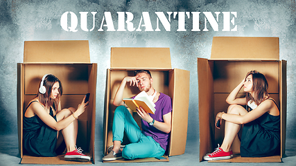 Image showing People at quarantine because of coronavirus spreading - sitting inside little boxes, staying home concept