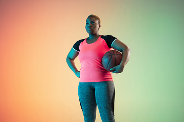 Image showing Young african-american plus size female model\'s training on gradient background