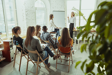 Image showing Female caucasian speaker giving presentation in hall at university or business centre workshop