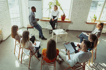 Image showing Female caucasian speaker giving presentation in hall at university or business centre workshop