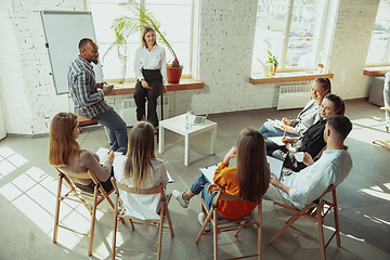 Image showing Female caucasian speaker giving presentation in hall at university or business centre workshop