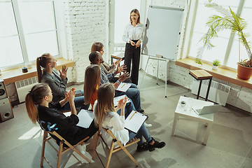 Image showing Female caucasian speaker giving presentation in hall at university or business centre workshop