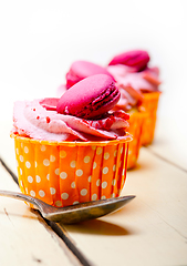 Image showing pink berry cream cupcake with macaroon on top