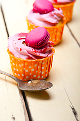 Image showing pink berry cream cupcake with macaroon on top