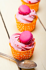 Image showing pink berry cream cupcake with macaroon on top