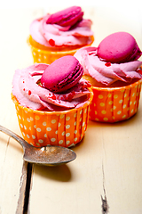 Image showing pink berry cream cupcake with macaroon on top