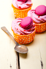 Image showing pink berry cream cupcake with macaroon on top