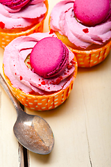 Image showing pink berry cream cupcake with macaroon on top