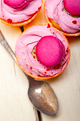 Image showing pink berry cream cupcake with macaroon on top