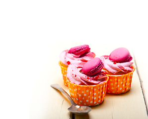 Image showing pink berry cream cupcake with macaroon on top