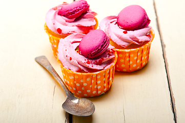 Image showing pink berry cream cupcake with macaroon on top